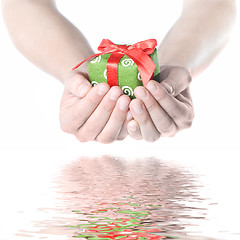 Image showing Hands holding gift with reflection isolated on white