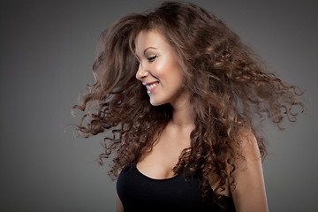 Image showing portrait of smiling woman with curly hair 