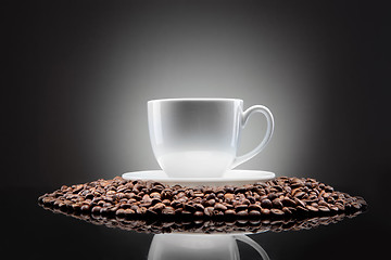 Image showing white cup with coffee beans on black