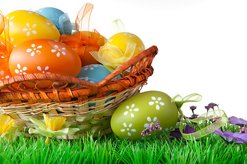 Image showing color easter eggs in basket isolated on white