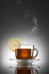 Image showing cup of hot tea with lemon and steam