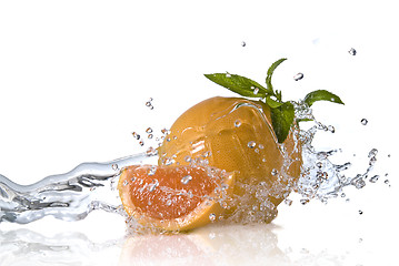 Image showing Water splash on orange with mint isolated on white