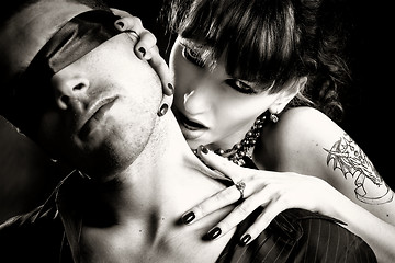 Image showing black and white photo of vampire woman bites a blind man