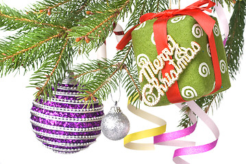 Image showing Christmas balls, gift and decoration on fir tree branch isolated