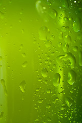 Image showing Green beer bottle with water drops isolated on white