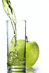 Image showing fresh apple juice in glass with green apple isolated on white