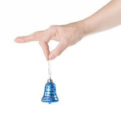 Image showing arm holding blue christmas bell isolated on white