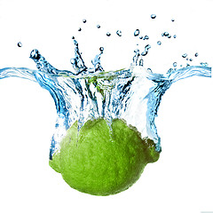 Image showing Fresh lime dropped into water with splash isolated on white