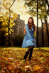 Image showing Woman in blue jaket posing in autumn park