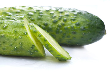 Image showing green cucumber with water drops isolated on white
