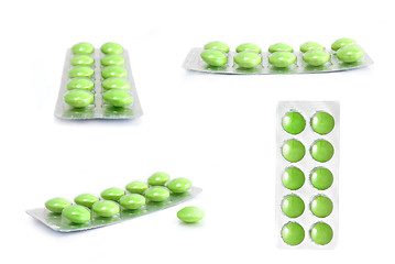 Image showing packs of green tablets isolated on white