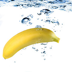 Image showing banana dropped into water isolated on white