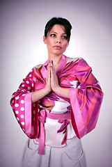 Image showing Atrractive girl in kimono pray