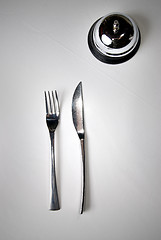 Image showing fork and knife on table with restaurant ring