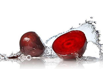 Image showing red beet with water splash isolated on white