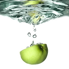 Image showing green apple dropped into water with splash isolated on white