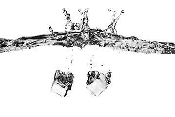 Image showing ice cubes dropped into water with splash isolated on white