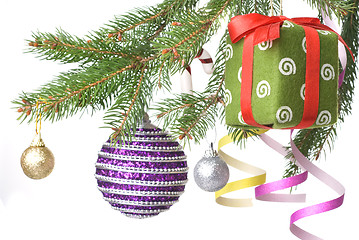 Image showing Christmas balls, gift and decoration on fir tree branch isolated