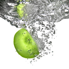 Image showing green apple dropped into water isolated on white