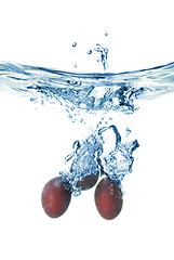 Image showing plum dropped into water