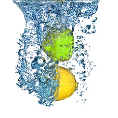 Image showing lemon and lime dropped into water with bubbles isolated on white