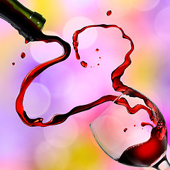 Image showing Heart from pouring red wine in goblet on color background