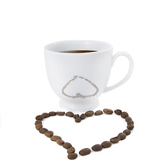 Image showing Coffee cup with heart from coffee beans isolated on white