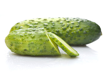 Image showing green cucumber with water drops isolated on white