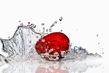 Image showing red beet with water splash isolated on white