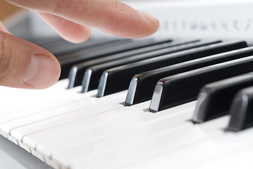 Image showing hand playing music on the piano