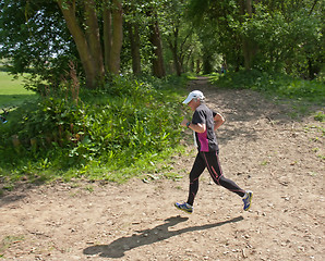 Image showing Older woman running race