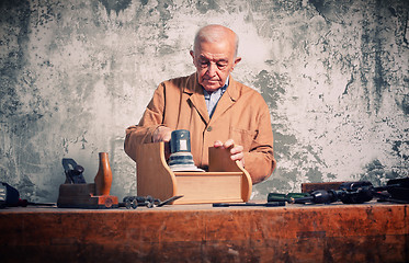 Image showing portrait of old caucasian carpenter with grunge background