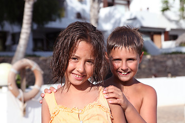 Image showing boy and girl playing near pool