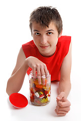 Image showing Boy with hand in lolly jar