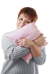 Image showing Happy woman hugs pink pillow