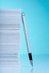 Image showing Fountain pen and stack of paper