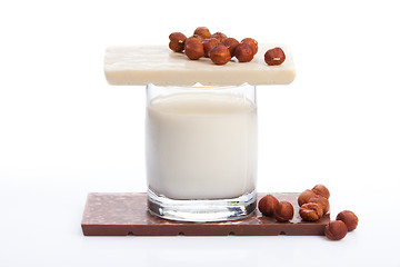 Image showing Glass with milk and chocolate with nuts