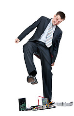 Image showing Businessman trampling foot motherboard