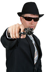 Image showing businessman in a hat and sunglasses with a gun