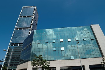 Image showing Office buildings with clouds reflecting in the windows
