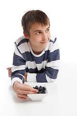 Image showing Boy eating blueberries