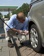 Image showing Inflating a tire