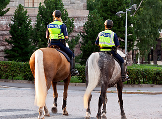 Image showing Two girls policeman on a horse