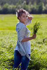 Image showing girl with a bundle of green grass