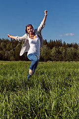 Image showing girl runs across the green grass