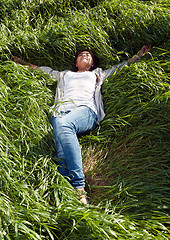 Image showing girl lying in the green grass