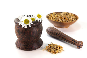 Image showing chamomile flowers with mortar