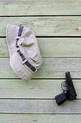 Image showing Hat and Pistol on Shabby Wooden Wall