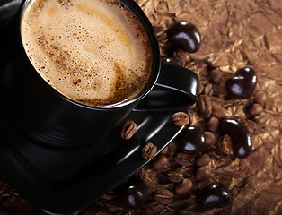 Image showing Coffee with milk, coffee beans and chocolate dragees.