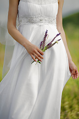 Image showing Photography of a bride holding bouquet, Side View